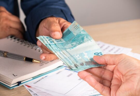 Businessman giving money to his partner when making contract. business and finance concept