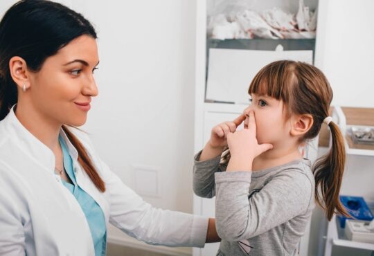 Little patient describing her breathing problem to pediatrician