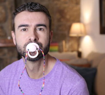 Spoiled grown up man licking a pacifier to control a tantrum.