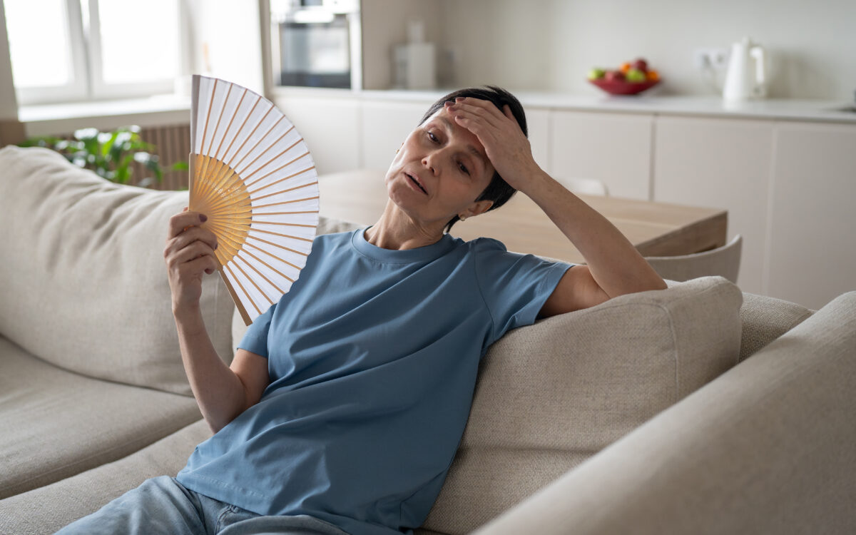 Tired stressed woman fanning home sweating hard no conditioning suffocating difficulty breathe