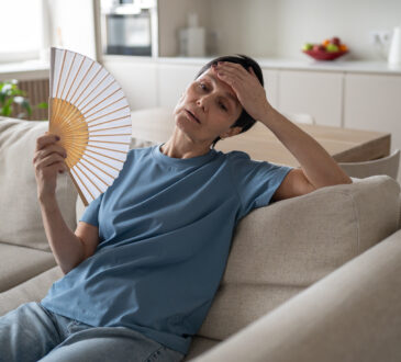 Tired stressed woman fanning home sweating hard no conditioning suffocating difficulty breathe