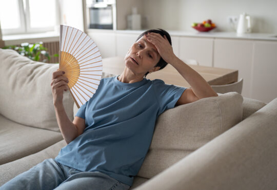 Tired stressed woman fanning home sweating hard no conditioning suffocating difficulty breathe