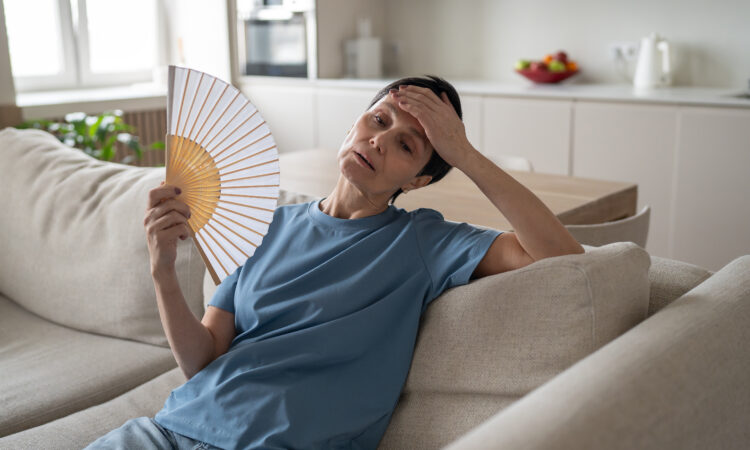 Tired stressed woman fanning home sweating hard no conditioning suffocating difficulty breathe