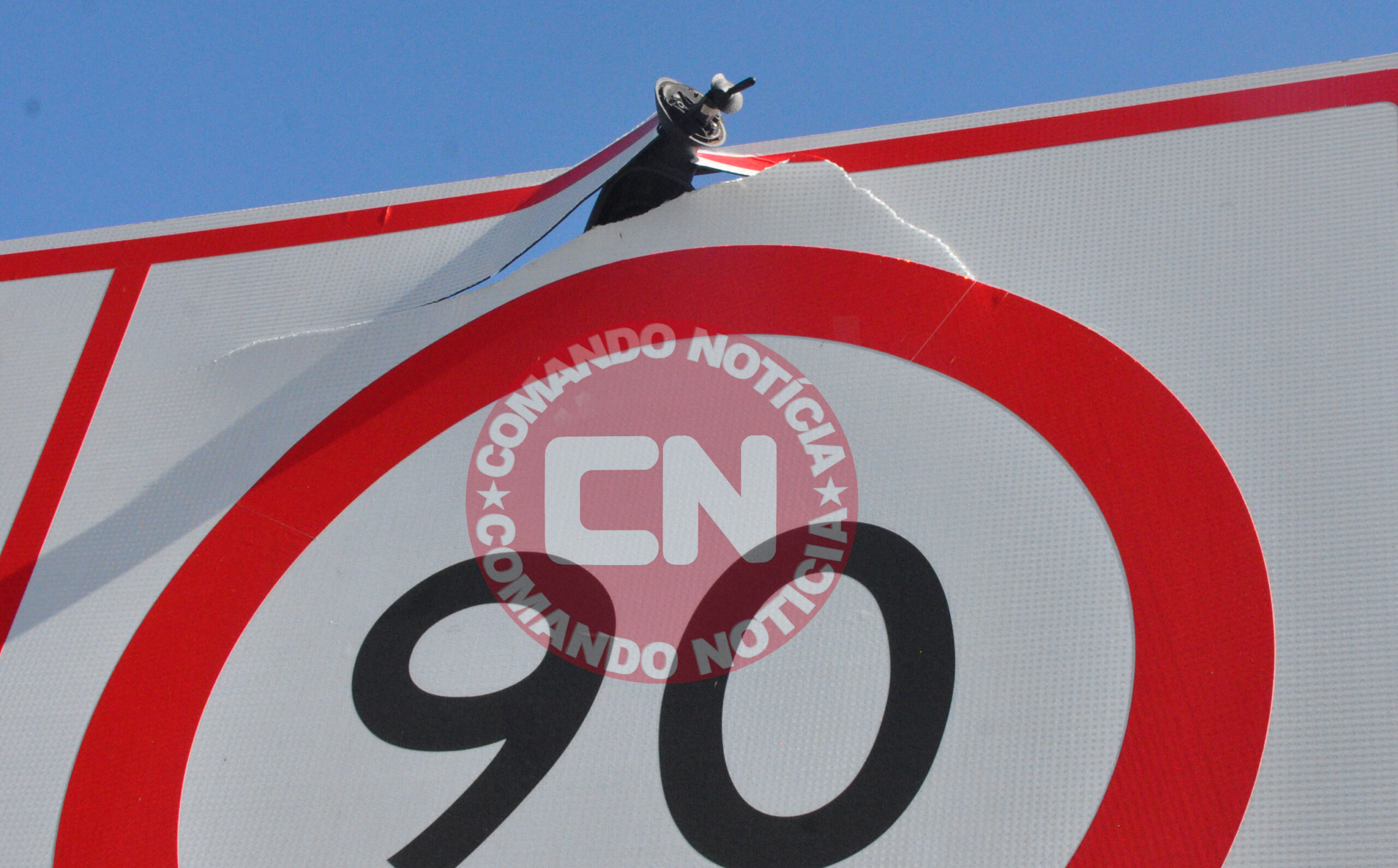 Retrovisor cravado na placa