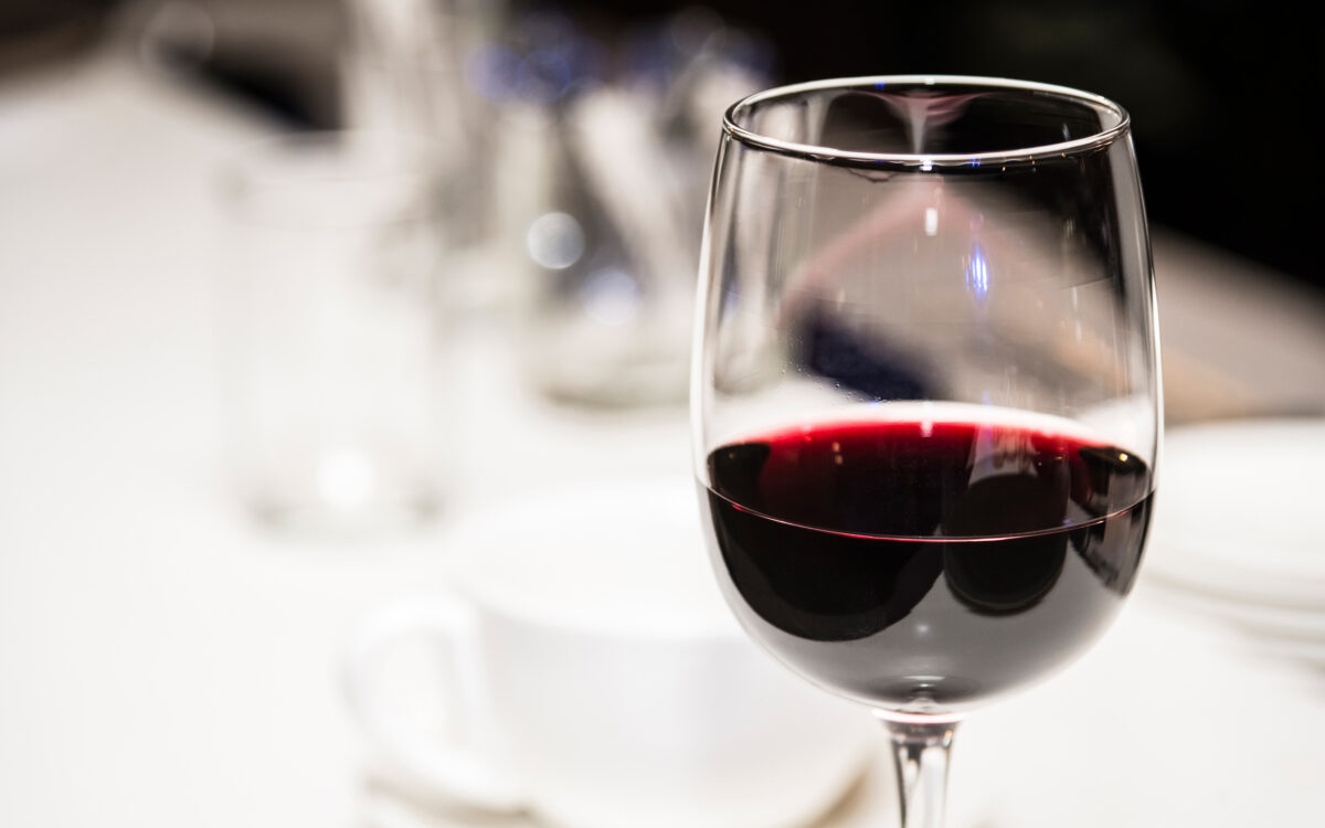Glass of red wine on a defocused background.