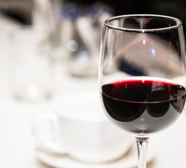 Glass of red wine on a defocused background.