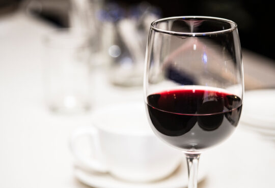 Glass of red wine on a defocused background.