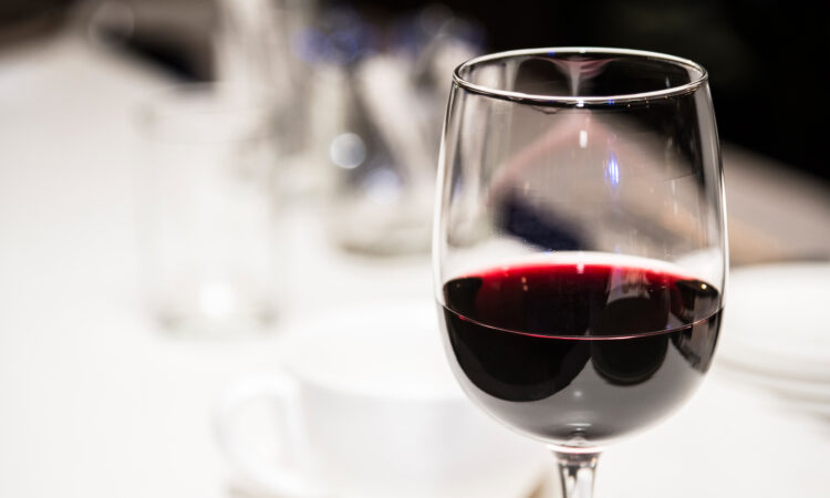Glass of red wine on a defocused background.