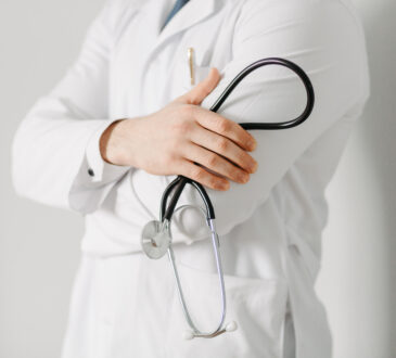 Portrait of a friendly doctor. isolated on gray