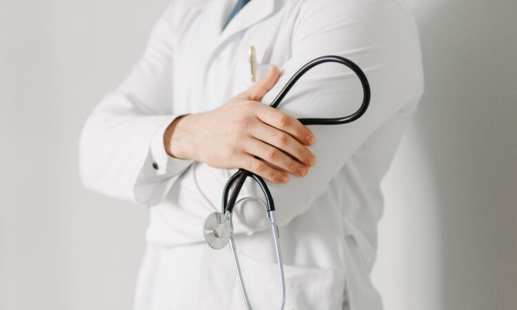 Portrait of a friendly doctor. isolated on gray