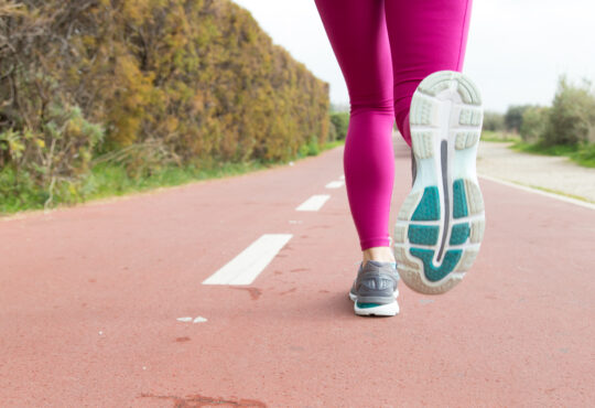 Close up of sportswoman training alone on stadium