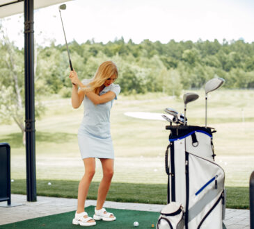 Beautiful girl playing golf on a golf course